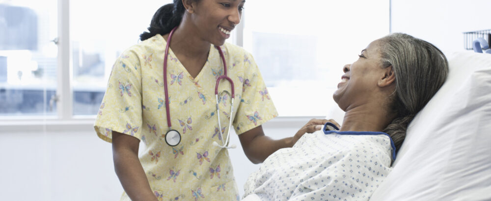 Nurse and patient talking in hospital